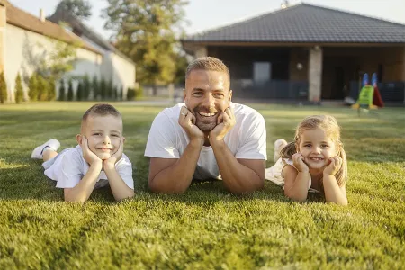 family laying outside on grass